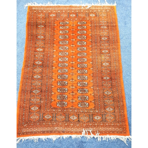 489 - BOKHARA STYLE RUG
on orange ground with fringing, 132 x 182cm