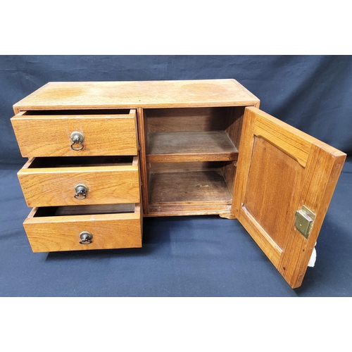 318 - 20th CENTURY OAK WORK BOX/ COLLECTORS CABINET
with three drawers, brass drop handles, and cupboard w... 