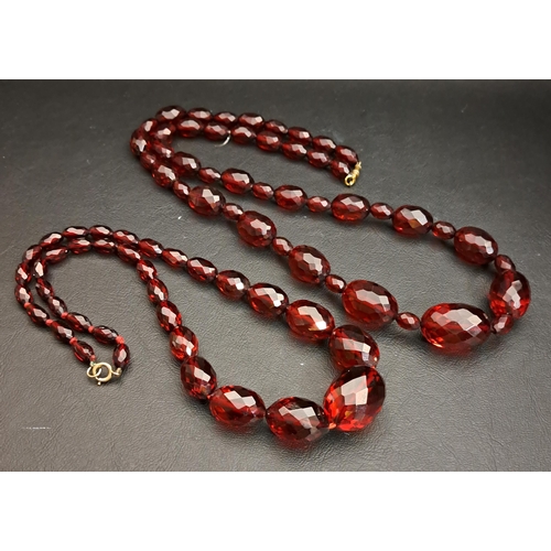 70 - TWO FACETED AMBER COLOURED BEAD NECKLACES
one 70cm long and approximately 61.2 grams, the other 44cm... 