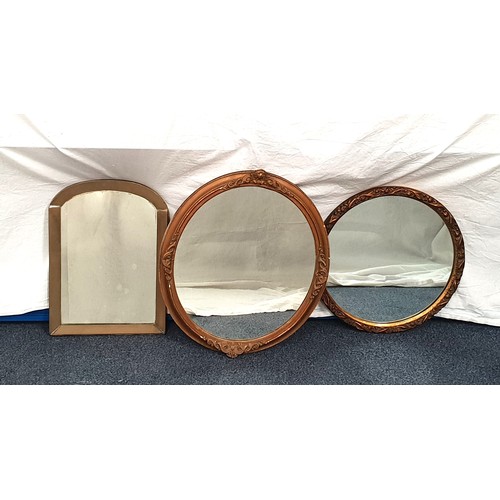 577 - SELECTION OF THREE WALL MIRRORS 
comprising a circular mirror with brass floral design frame, an ovu... 