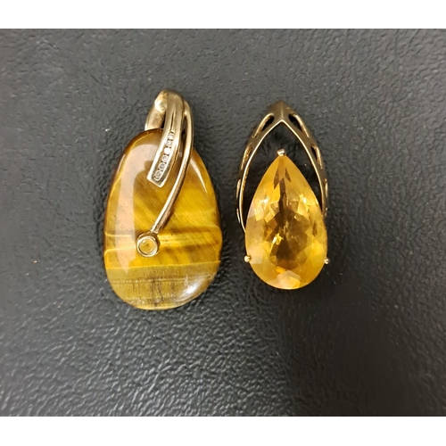 68 - TWO NINE CARAT GOLD MOUNTED PENDANTS
one tiger's eye pendant with small diamonds, 3.4cm high; and th... 