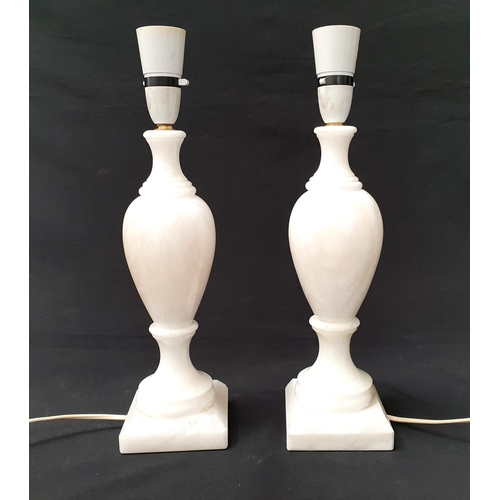 367 - PAIR OF ALABASTER TABLE LAMPS
of baluster design and square bases, 30cm to light fitting