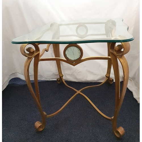 484 - GILT FINISHED WROUGHT IRON AND GLASS SIDE TABLE
the shaped glass top above gilt wrought iron base co... 