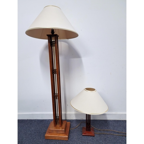 507 - STAINED WOOD STANDARD LAMP
the square pierced column with central brass pole; together with a simila... 