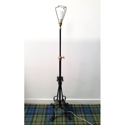 581 - WROUGHT IRON STANDARD LAMP
with brass mounts and scroll work, 140cm to light fitting