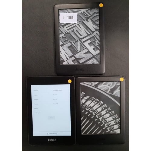 155 - THREE AMAZON KINDLE E-READERS
comprising a Paperwhite 4, serial number G000 T607 8346 0L58; and two ... 