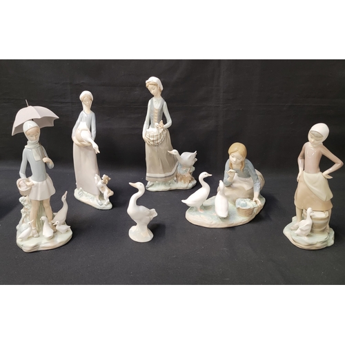 262 - FIVE LLADRO WOMEN AND GEESE FIGURINES
comprising a kneeling girl feeding two geese; a girl holding a... 