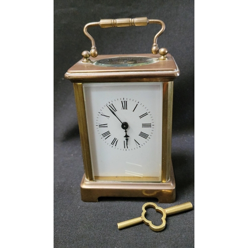 374 - BRASS CASED CARRIAGE CLOCK
the white enamel dial with Roman numerals, complete with key, 12cm high