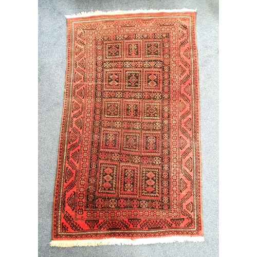 653 - TURKMAN WOOLLEN RUG
with reds and spots of green, 190 x 112cm