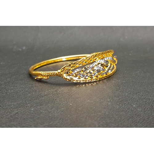 6 - TWENTY-TWO CARAT GOLD BANGLE
with pierced and cut detail to the two tone top section, approximately ... 