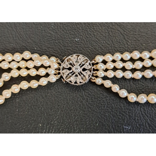 114 - IMPRESSIVE FOUR STRAND PEARL NECKLACE
with diamond set unmarked gold clasp, the longest strand appro... 