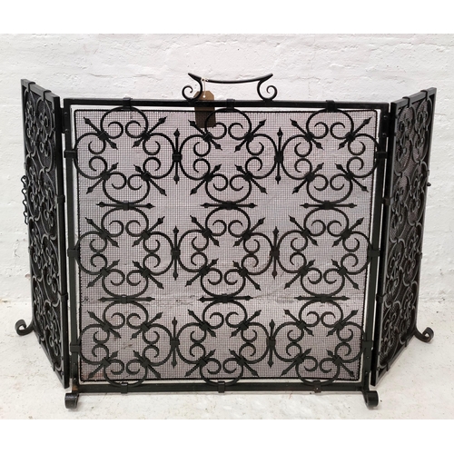 WROUGHT IRON TRIPTYCH FIRE GUARD
with scroll work and chain to fix fold at back, fully extended 70 x 117cm