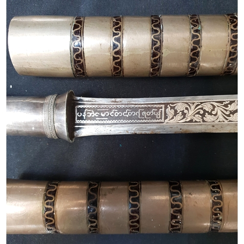 525 - PAIR OF 19th CENTURY BURMESE DHA SWORDS
with silver damascened hilt depicting figures with animal he... 