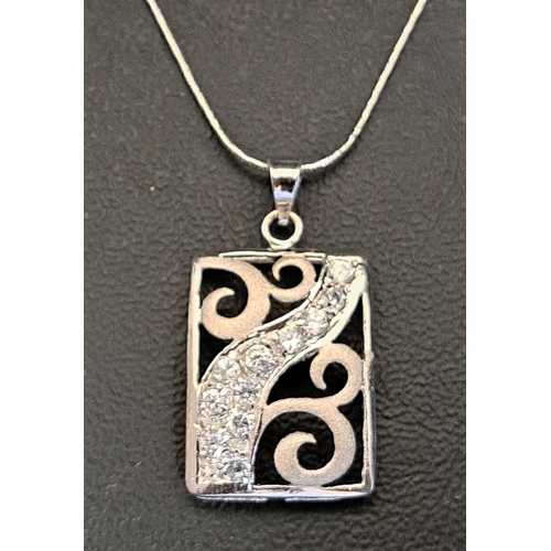 24 - CZ SET EIGHTEEN CARAT WHITE GOLD PENDANT
on eighteen carat white gold chain, the rectangular pierced... 