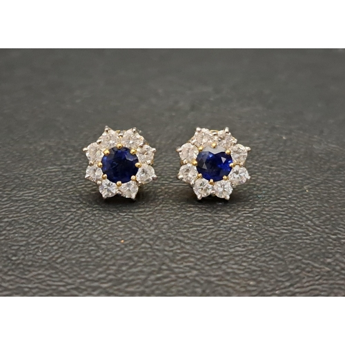 28 - PAIR OF SAPPHIRE AND DIAMOND CLUSTER EARRINGS
each earring with a central round cut sapphire of appr... 