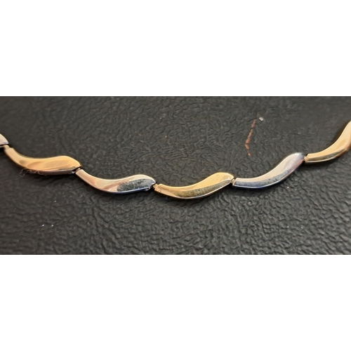 41 - NINE CARAT TWO TONE GOLD NECKLACE
with alternating white and yellow gold links, approximately 9.6 gr... 
