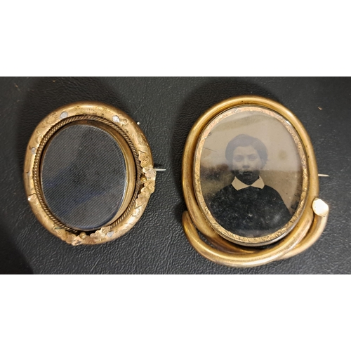 44 - TWO VICTORIAN PINCHBECK MOUNTED MOURNING BROOCHES
one with central glazed swivel locket section, one... 