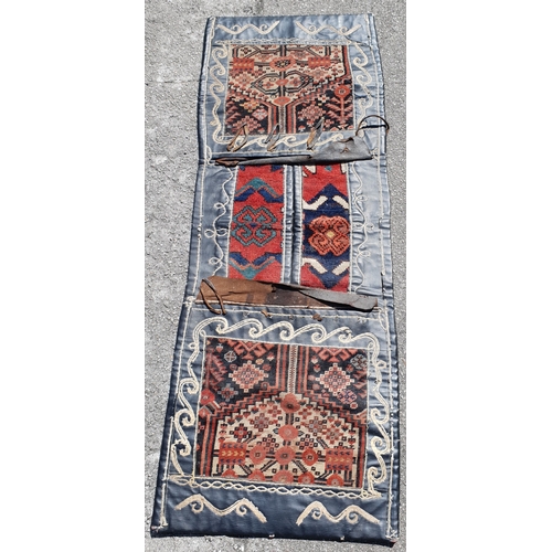 408 - DOUBE SIDED BELOUSCH CARPET SADDLE BAG 
made of leather and wool with poppy motif and geometric moti... 