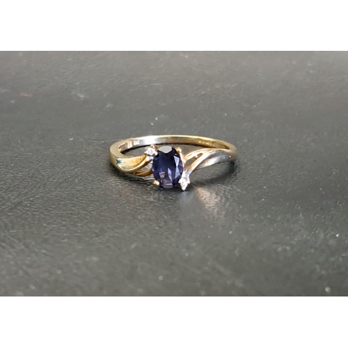 56 - BLUE GEM AND DIAMOND SET RING
the oval cut blue gemstone (possibly iolite) approximately 0.75cts, in... 