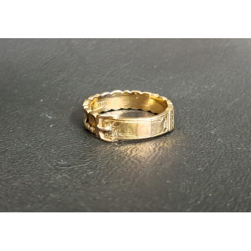 57 - TEN CARAT GOLD BUCKLE DESIGN RING
with indented panels and engraved decoration, ring size O and appr... 