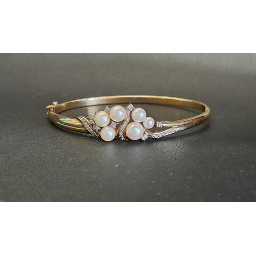 61 - PEARL AND DIAMOND SET NINE CARAT GOLD BANGLE
the six pearls in pierced diamond set surround, in nine... 
