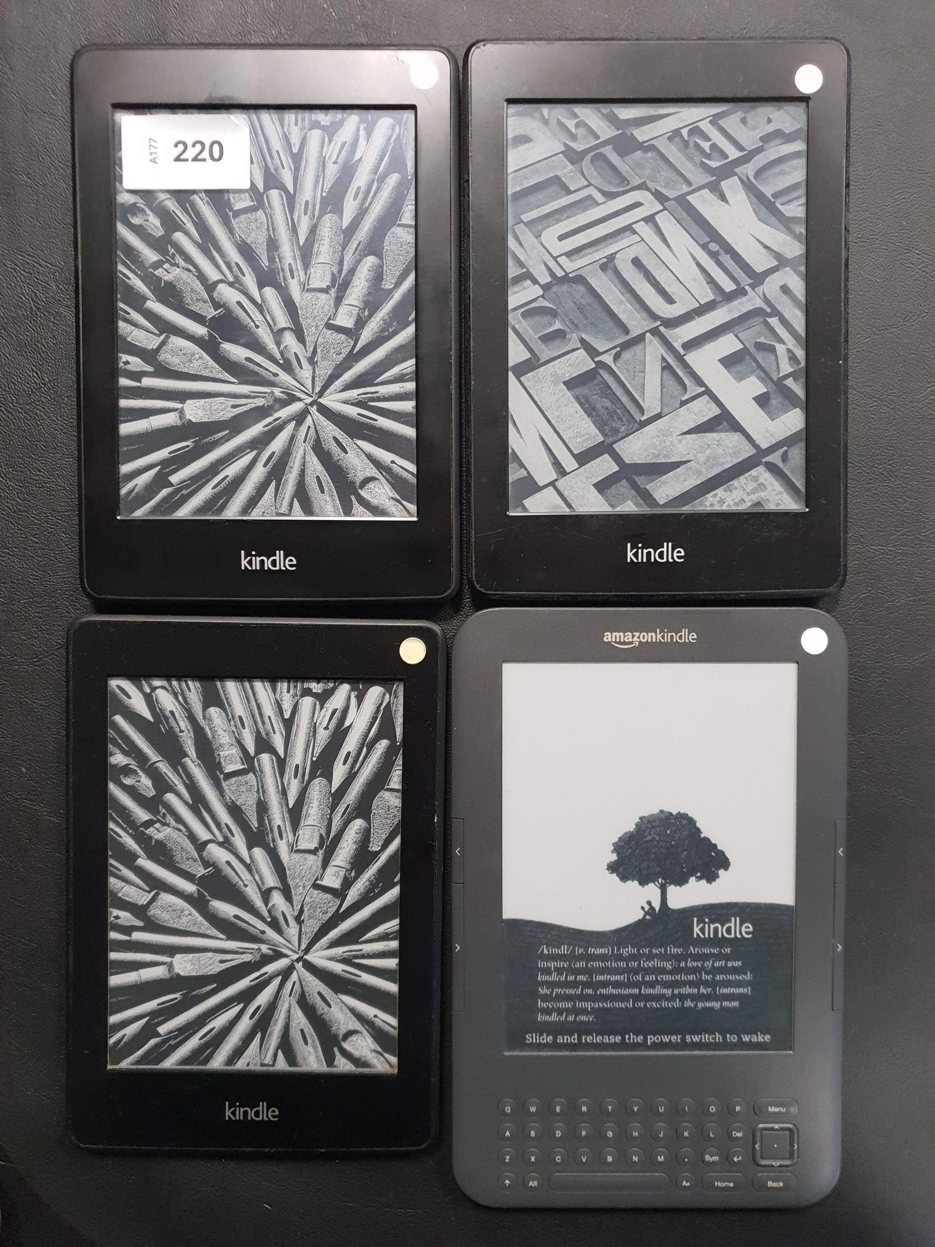 FOUR AMAZON KINDLE E-READERS comprising three Paperwhite 2, serial ...