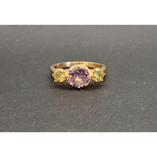 39 - AMETHYST AND PERIDOT THREE STONE RING
the central round cut amethyst approximately 1ct, flanked by r... 