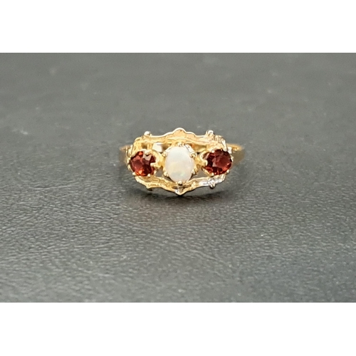 27 - OPAL AND GARNET THREE STONE RING
the central oval cabochon opal flanked by a garnet to each side, on... 