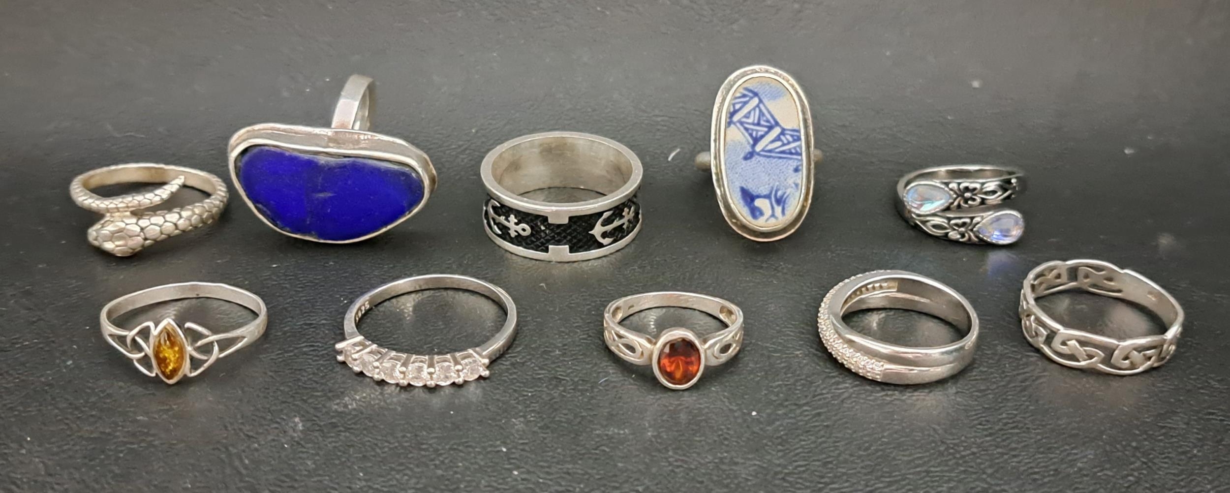 TEN SILVER RINGS including one set with a blue and white glazed ceramic ...
