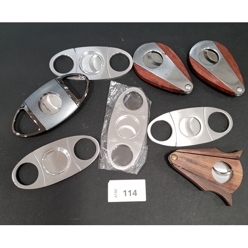 114 - EIGHT CIGAR CUTTERS 
Note: You must be over the age of 18 to bid on this lot.