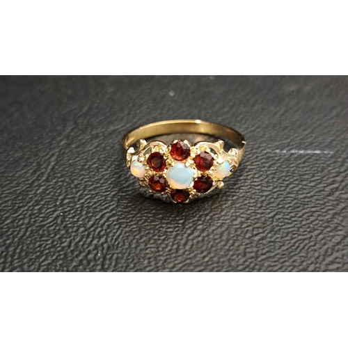 14 - GARNET AND OPAL CLUSTER DRESS RING
the central cabochon opal in six opal surround and with further o... 