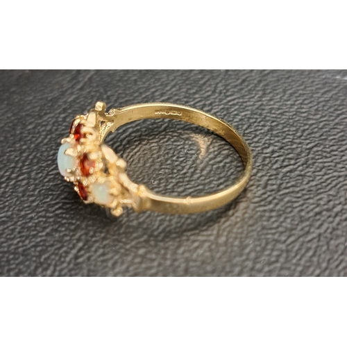 14 - GARNET AND OPAL CLUSTER DRESS RING
the central cabochon opal in six opal surround and with further o... 