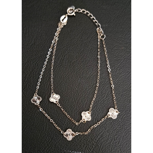 38 - EIGHTEEN CARAT WHITE GOLD BRACELET
the double strand bracelet with quatrefoil motif decoration, appr... 