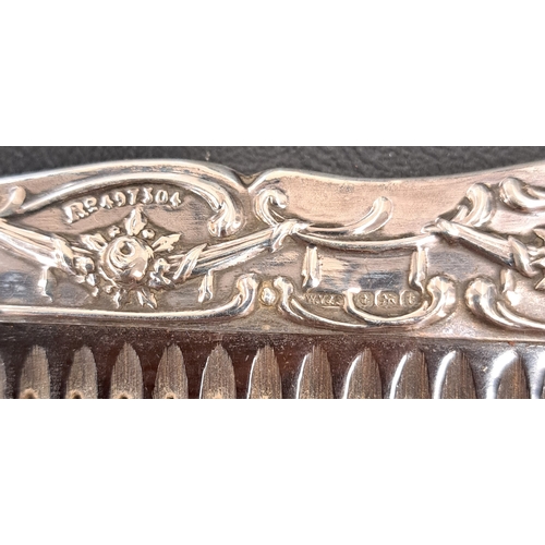 166 - GEORGE V SILVER BACKED DRESSING TABLE SET 
comprising a brush, a mirror and a comb, all with scroll ... 