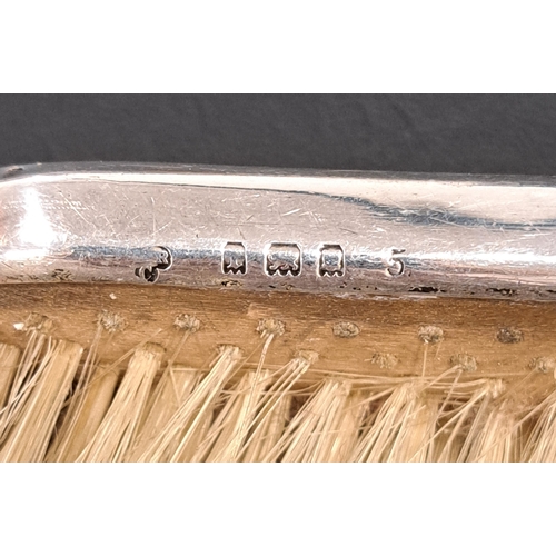 167 - GEORGE V SILVER BACKED DRESSING TABLE SET
comprising a hairbrush, a clothes brush and a comb, all wi... 