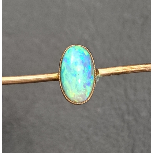 18 - OPAL SET BAR BROOCH
the oval cabochon opal measuring approximately 7 x 4mm, in unmarked nine carat g... 