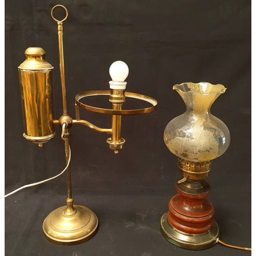 TWO TABLE LAMPS 
one with frosted glass shade, brass accents and wooden base, in the style of a paraffin lamp, 39cm high; the other a brass Kosmos Brenner style table lamp, 56cm high
