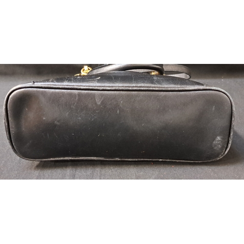 385 - AIGNER MUNICH BOWLER BAG
late 1980s, in black leather, gold-tone hardware, with dual top handles, a ... 