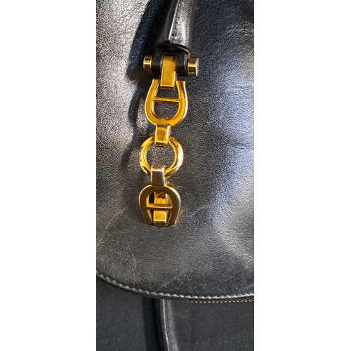 385 - AIGNER MUNICH BOWLER BAG
late 1980s, in black leather, gold-tone hardware, with dual top handles, a ... 