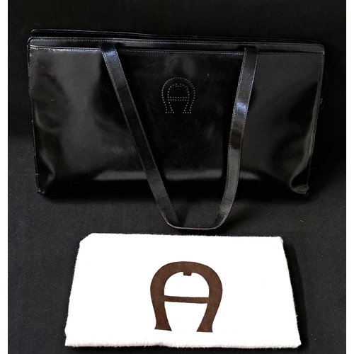 AIGNER MUNICH SHOPPER TOTE BAG
early-to-mid 1990s, in black glossy leather, gold-tone hardware, with dual top handles, internal zip pocket, black monogrammed lining, zip top closure, magnetic front compartment and matching dust bag