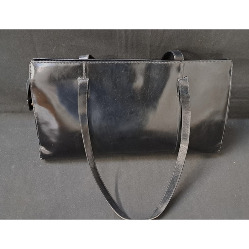 386 - AIGNER MUNICH SHOPPER TOTE BAG
early-to-mid 1990s, in black glossy leather, gold-tone hardware, with... 
