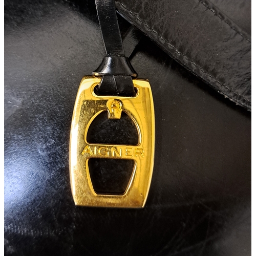 386 - AIGNER MUNICH SHOPPER TOTE BAG
early-to-mid 1990s, in black glossy leather, gold-tone hardware, with... 