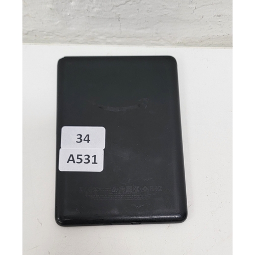 34 - AMAZON KINDLE BASIC 3/ MODEL: J9G29R- BLACK. Screen bleed to right hand side.