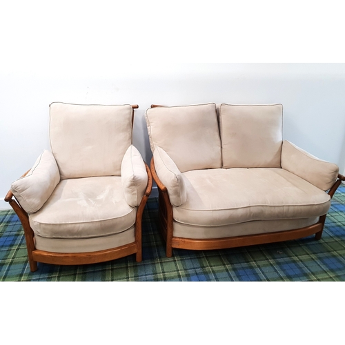 ERCOL 'RENAISSANCE' TWO SEAT SOFA AND MATCHING ARMCHAIR
design number 1068, each with curved stick back support and raised on four legs, the cushions upholstered in suede cream coloured fabric, the two seat sofa 144 x 96 x 71cm and the armchair 90 x 96 x 71cm (2)