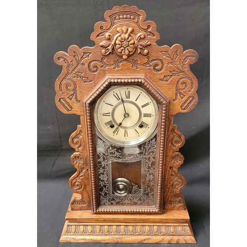 ANSONIA GINGERBREAD CLOCK
featuring intricate carved wooded frame, etched glass panel, and face with Roman numerals, 58cm high