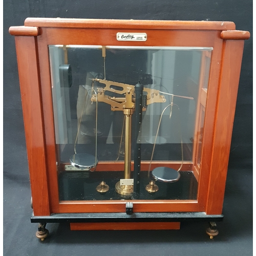 VINTAGE CHAINOMATIC MODEL 101 ANALYTIC BALANCE BY MAKER L. OERTLING LTD
with delicate brass balance beam, dual hanging pan inside a glass and polished mahogany display cabinet and with leveling feet at the base, 43 x 48 x 23cm