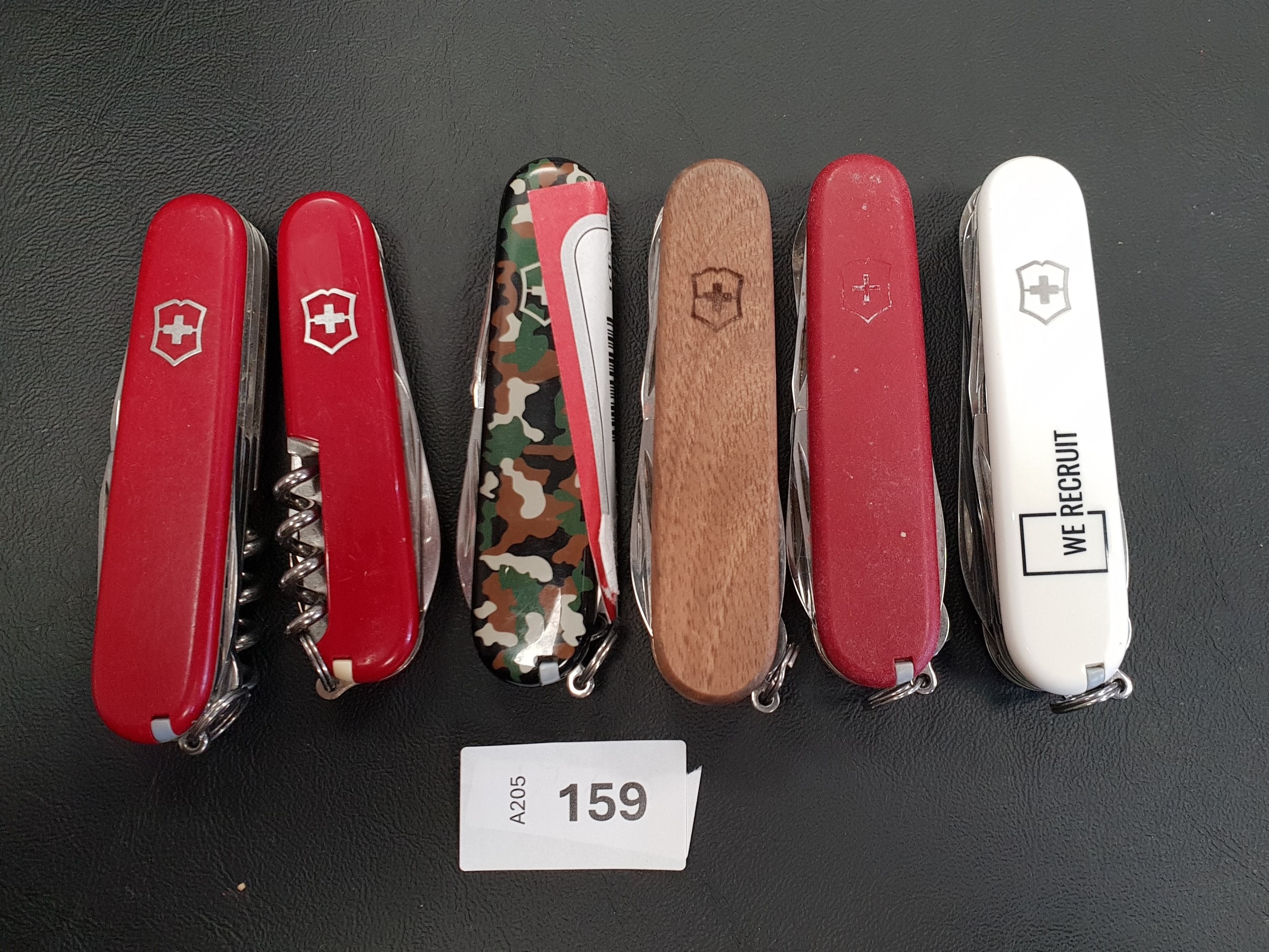 SIX VICTORINOX SWISS ARMY KNIVES of various sizes and designs Note: You ...