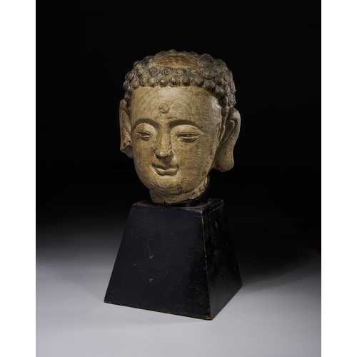 31 - A POLYCHROME PAINTED STONE HEAD OF A BUDDHA, YUAN DYNASTY OR EARLIER

 Height with stand: 34cm

 Pri... 