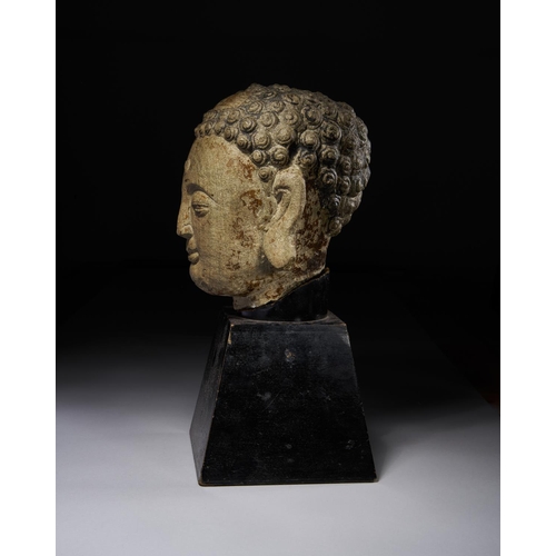 31 - A POLYCHROME PAINTED STONE HEAD OF A BUDDHA, YUAN DYNASTY OR EARLIER

 Height with stand: 34cm

 Pri... 