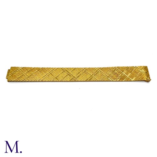 37 - A Gold Woven Bracelet by Georges Lenfant.

The 18ct yellow gold bracelet in woven and striated patte... 